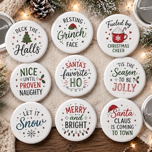 May include: A collection of nine round white pinback buttons featuring various Christmas-themed designs and text including Deck the Halls, Resting Grinch Face, Fueled by Christmas Cheer, Nice Until Proven Naughty, Santa's Favorite HO, 'Tis the Season to be Jolly, Let it Snow, Merry and Bright, and Santa Claus is Coming to Town.