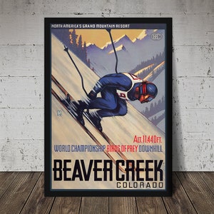 May include: Vintage travel poster for Beaver Creek, Colorado, a North American Grand Mountain Resort. The poster features a skier in a blue and white suit, racing downhill. The text reads "Alt. 11,440 ft. World Championship Birds of Prey Downhill Beaver Creek Colorado."
