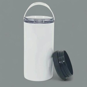 May include: A white insulated tumbler with a clear lid and a white handle. The black lid is detached and resting next to the tumbler. The tumbler is cylindrical and appears to be made of stainless steel.