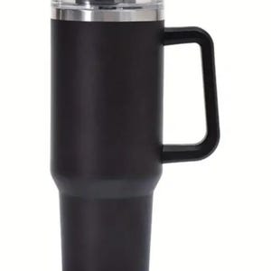 May include: Black stainless steel travel mug with a handle and a clear lid. The mug has a double-walled design to keep drinks hot or cold.
