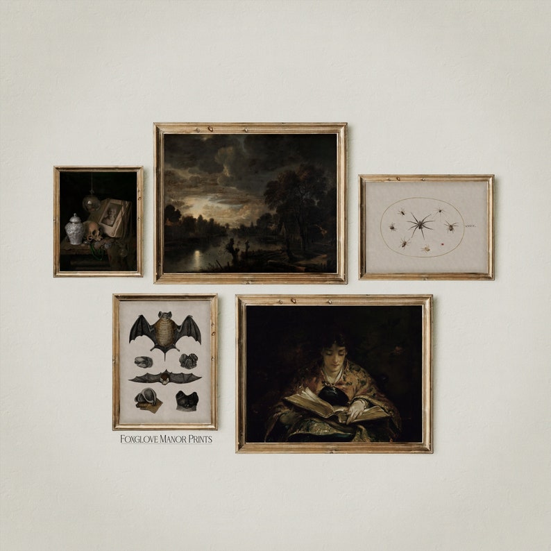 May include: A gallery wall with five framed prints. The prints feature a landscape scene, a bat, a spider, and two portraits. The prints are all in gold frames and are arranged in a symmetrical pattern.