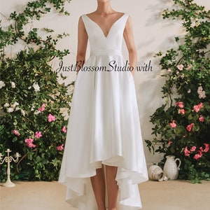Minimalist Ivory Satin Hi-Lo Wedding Dress: Sleeveless Open Back with Bow & Pockets