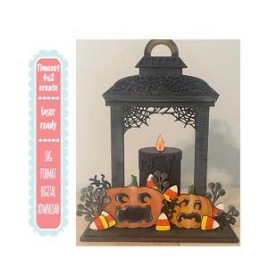 May include: A black wooden Halloween lantern with a spiderweb design, two carved pumpkins, and a black candle. The pumpkins are decorated with candy corn. The text "Timeout 4u2 create" is on the left side.