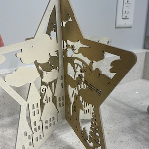 Christmas Stars svg digital file there are two stars with Christmas scenes on them one is of Christmas Night and the other is the Nativity