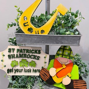 Green Day glowforge svg download file. This tiered tray set has Leprechaun gnome a horseshoe and a sign. You need this file for the holiday.