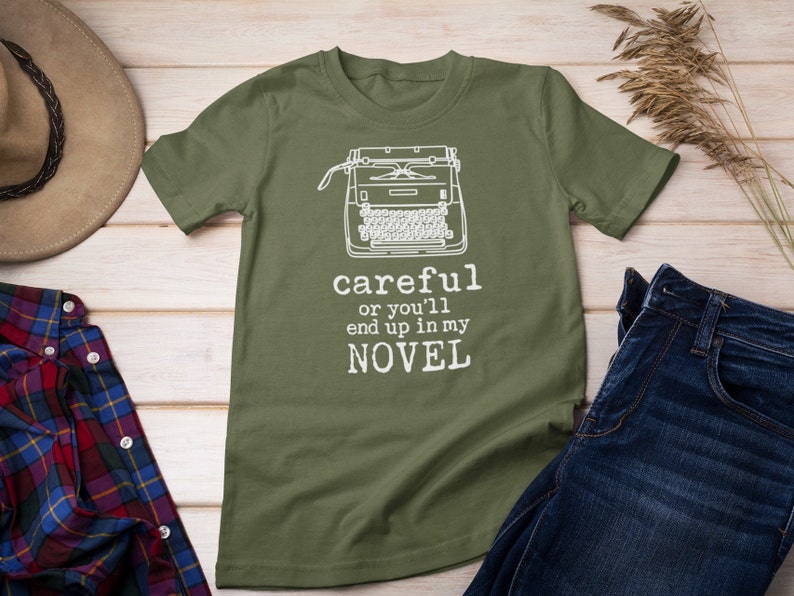 May include: A green t-shirt with a white typewriter graphic and the text "careful or you'll end up in my NOVEL".