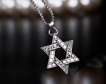 Può includere: Una collana con catena d'argento con un ciondolo a forma di stella di David in argento dettagliato.