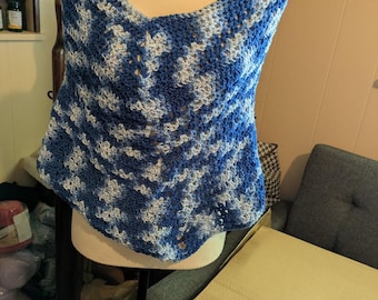 May include: A blue and white crocheted shawl with a lacy pattern. The shawl is draped over a white mannequin.