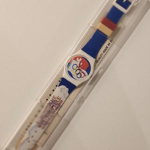 Reloj Swatch de 1996, colección conmemorativa del centenario de St. Moritz 1928, Atlanta 1996, sin probar, sin usar, en caja, vintage, retro, fabricado en Suiza.