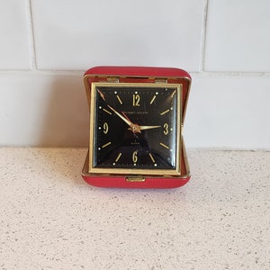 MCM travel alarm clock, Phinney Walker, red plastic case, working, mechanical, midcentury, vintage, retro, iconic, desk, office, road trip