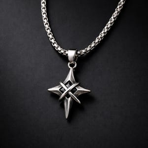May include: A silver-toned pendant necklace with a starburst design. The pendant features a four-pointed star with intersecting lines and a dark center, suspended from a chain necklace. The background is black.