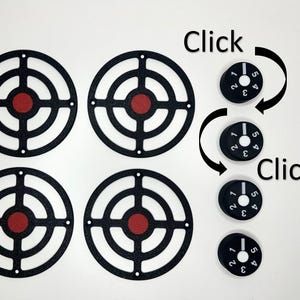 May include: Four black circular target frames with red centres arranged in a square grid, accompanied by four small black cylindrical knobs. Each knob features white numbers 1 through 5 and a white indicator line, with the text Click visible.
