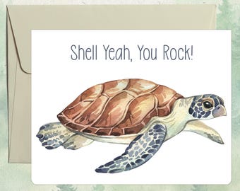 May include: A white greeting card featuring a watercolor illustration of a sea turtle with a brown shell and patterned flippers. The text Shell Yeah, You Rock! is printed in dark gray above the turtle. A light tan envelope is positioned behind.
