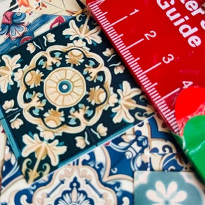 May include: A close-up of a variety of colorful patterned tiles with a red ruler labeled "Letter Guide" on top. The ruler has markings from 0 to 4.