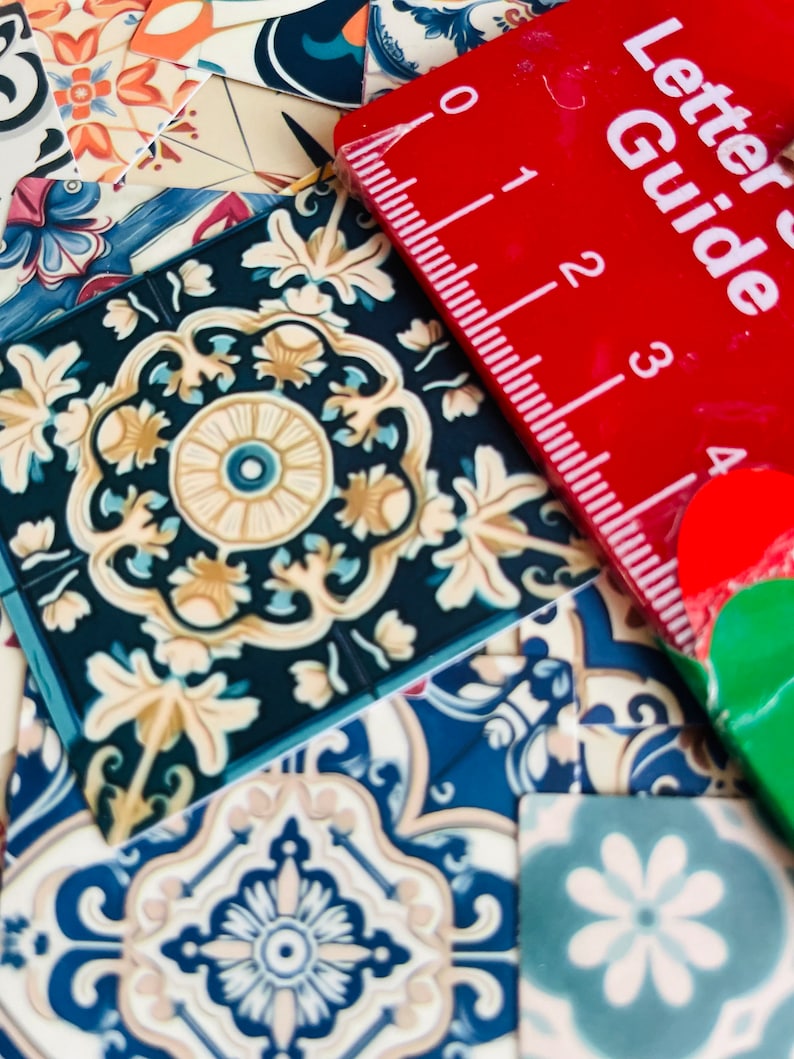 May include: A close-up of a variety of colorful patterned tiles with a red ruler labeled "Letter Guide" on top. The ruler has markings from 0 to 4.