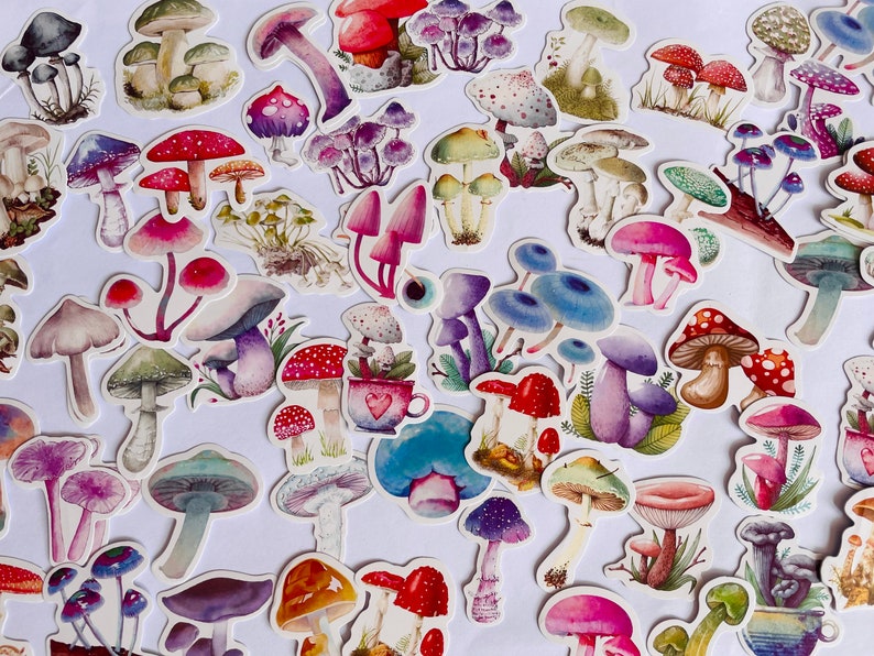 May include: A collection of colorful mushroom stickers with various designs and styles. The stickers feature different colors, shapes, and sizes of mushrooms, including red, purple, blue, and green.