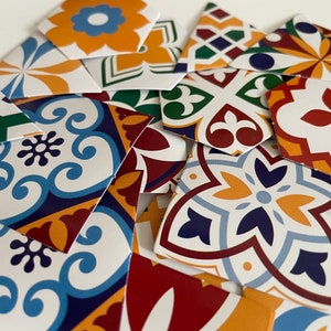 May include: Assortment of colorful patterned ceramic tiles with geometric designs in shades of blue, yellow, red, and green. The tiles are perfect for adding a touch of traditional Spanish or Moroccan style to any space.