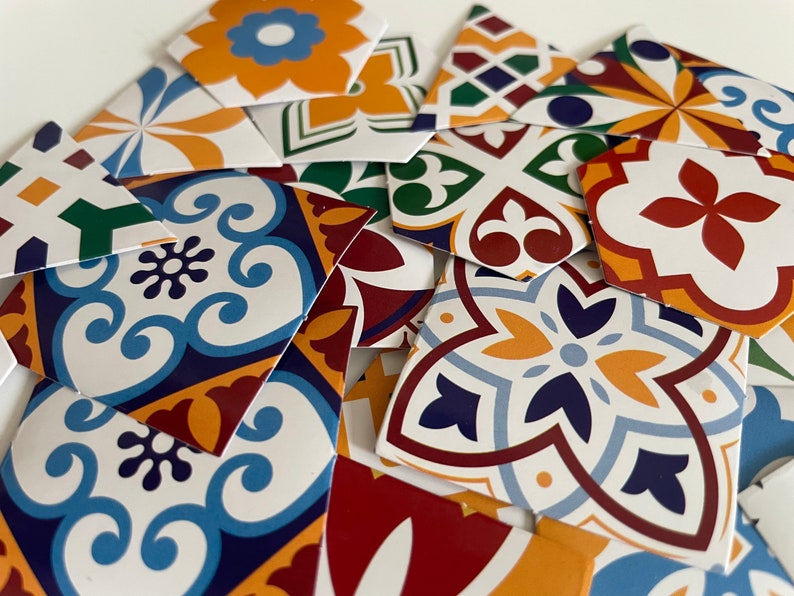 May include: Assortment of colorful patterned ceramic tiles with geometric designs in shades of blue, yellow, red, and green. The tiles are perfect for adding a touch of traditional Spanish or Moroccan style to any space.