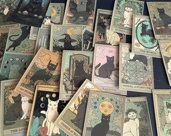 May include: A collection of tarot cards featuring illustrations of cats in various poses and settings. The cards have a vintage aesthetic with muted colors and include titles like "The World" and "Aquarius."