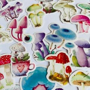 May include: A collection of colorful mushroom stickers with various designs, including red and white polka dot mushrooms, blue mushrooms, and purple mushrooms.