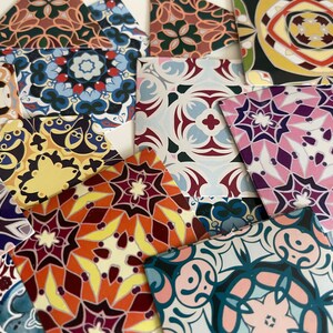 May include: A collection of colorful patterned paper squares with intricate geometric designs. The patterns feature a variety of colors, including red, blue, green, yellow, and purple.