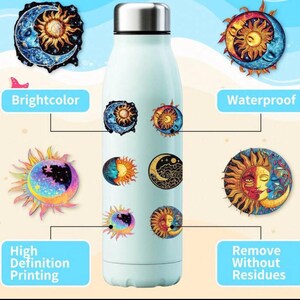 May include: A light blue water bottle with a silver cap, adorned with colorful stickers featuring sun and moon designs. The stickers are labeled "Brightcolor", "Waterproof", "High Definition Printing", and "Remove Without Residues".