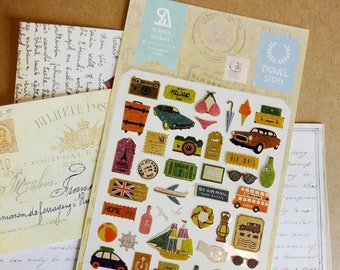 May include: A sheet of vintage-style travel stickers featuring images of airplanes, cars, luggage, and other travel-related items. The stickers are printed on a cream-colored background with a distressed look. The sheet also includes the text "TRAVEL STORY" in a blue banner.
