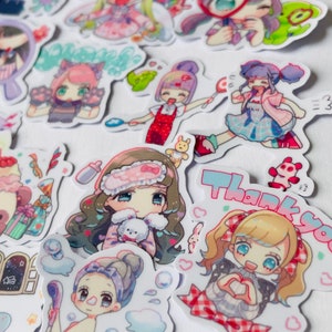 May include: A collection of colourful stickers featuring cartoon characters with different expressions and poses. The stickers are on a white background and include phrases like "Thank You" and "Welcome".