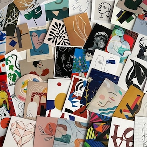 May include: A collection of colourful abstract art stickers featuring geometric shapes, line drawings, and faces. The stickers are printed on white paper and have a matte finish.