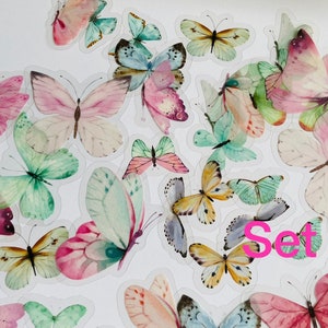May include: A set of colourful butterfly stickers with a watercolour effect. The stickers are on a white background and feature a variety of butterfly designs, including pink, green, blue, and yellow butterflies. The text "Set C" is visible in the lower right corner of the image.