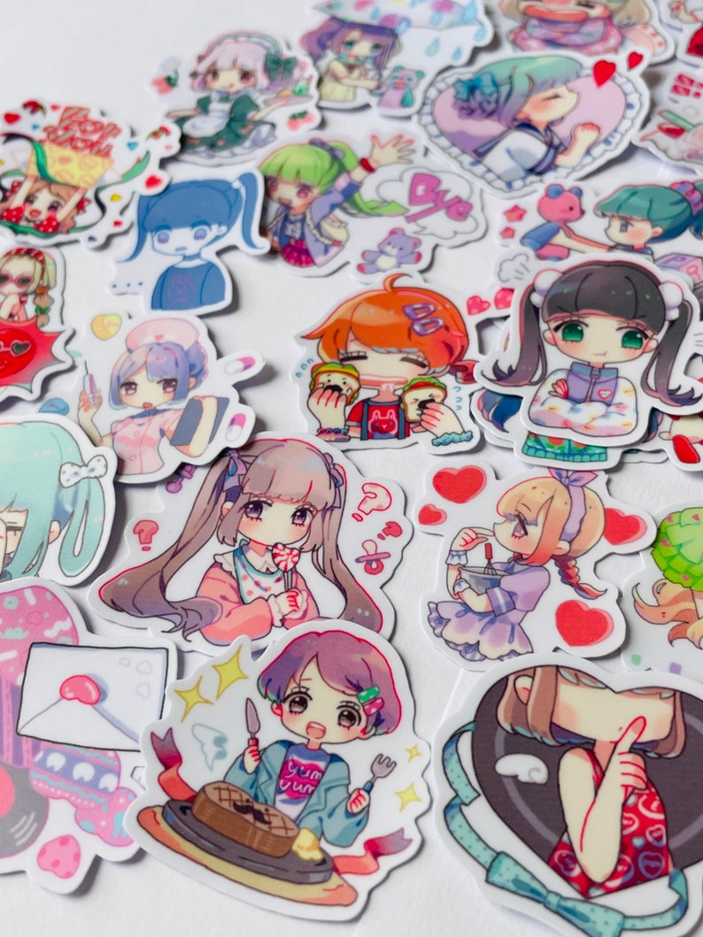 May include: A collection of colourful stickers featuring cartoon characters with different expressions and poses. The stickers are on a white background and include hearts, stars, and other decorative elements.