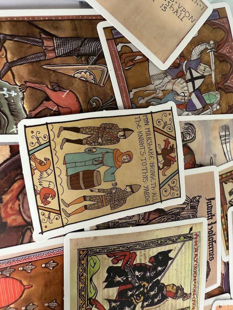 May include: A selection of medieval-themed cards, depicting knights, soldiers, and historical scenes. The cards showcase detailed illustrations with a vintage appearance, incorporating text and decorative borders. The colour scheme includes browns, reds, and blues.