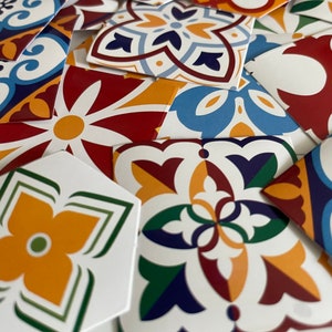 May include: A collection of colorful patterned ceramic tiles with geometric designs in shades of blue, red, yellow, green, and white.