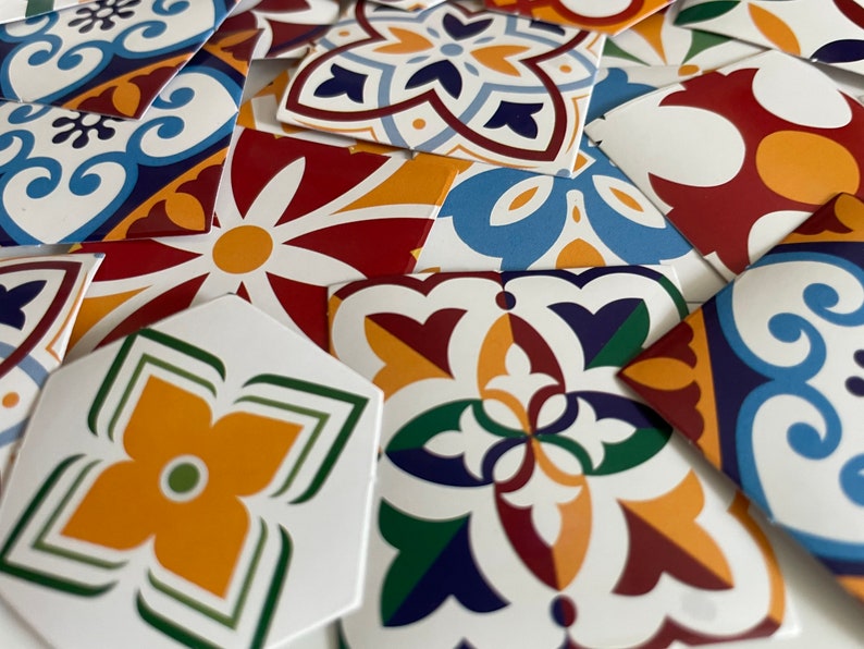 May include: A collection of colorful patterned ceramic tiles with geometric designs in shades of blue, red, yellow, green, and white.