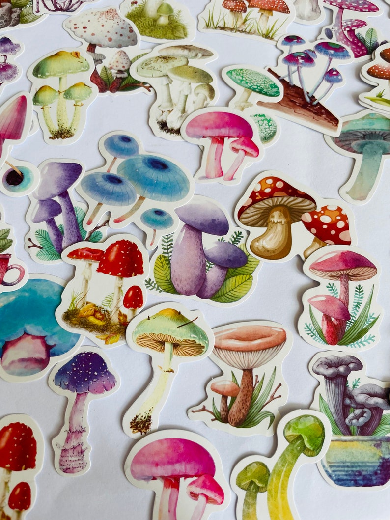 May include: A collection of colorful mushroom stickers with various designs and styles. The stickers feature different colors, shapes, and sizes of mushrooms, including red, blue, green, purple, and pink.