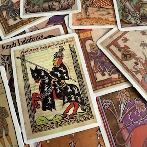 May include: A selection of vintage tarot cards with medieval illustrations. The cards depict knights, horses, and figures in historical dress, with decorative borders and text. The colour scheme includes earthy tones, reds, and blues.