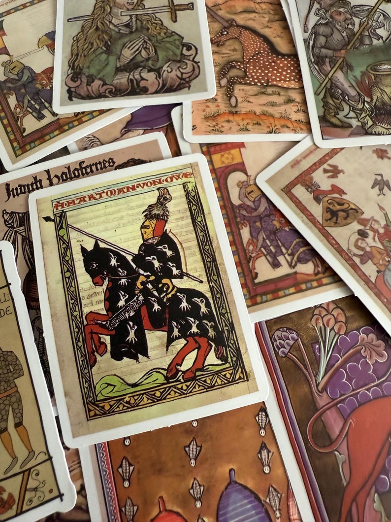 May include: A selection of vintage tarot cards with medieval illustrations. The cards depict knights, horses, and figures in historical dress, with decorative borders and text. The colour scheme includes earthy tones, reds, and blues.