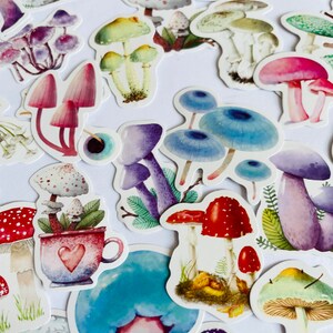 May include: A collection of colorful mushroom stickers with various designs, including red and white mushrooms, blue mushrooms, and green mushrooms. The stickers are perfect for adding a whimsical touch to journals, planners, and other craft projects.
