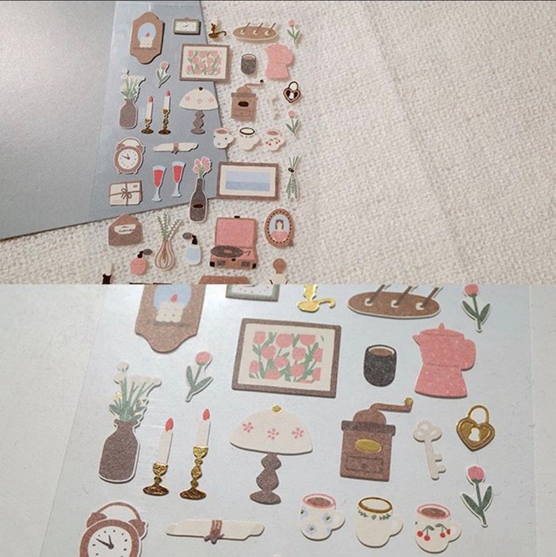 May include: A sheet of stickers featuring illustrations of home decor items in a vintage style. The stickers are in shades of pink, brown, and white. The stickers include a lamp, a clock, a vase, a picture frame, a record player, a coffee pot, a coffee grinder, and a key.