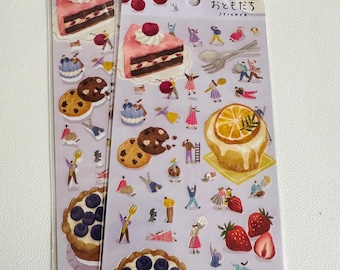 May include: Two sheets of stickers featuring illustrations of cakes, pastries, fruit, and people. The stickers are on a purple background and have the Japanese text "ひっそり おやつ  sticker" which translates to "Quietly Snacks Sticker".