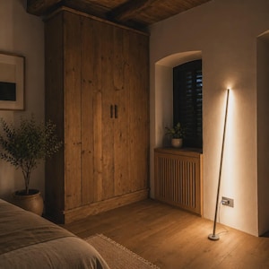 Bright rustic living room with wooden beams, beige sofa, natural textures and handcrafted minimalist lamps by Tommaso Cristofaro creating warm atmospheric light.