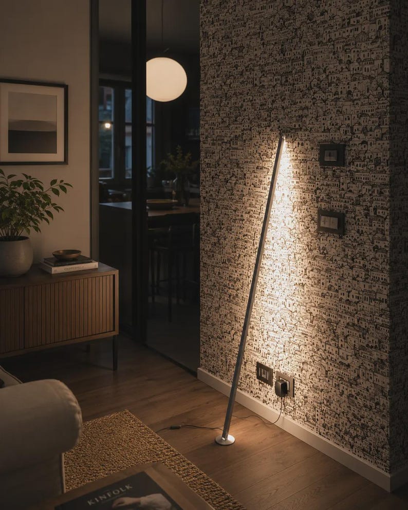 Bright rustic living room with wooden beams, beige sofa, natural textures and handcrafted minimalist lamps by Tommaso Cristofaro creating warm atmospheric light.