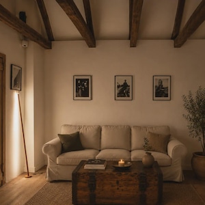 Bright rustic living room with wooden beams, beige sofa, natural textures and handcrafted minimalist lamps by Tommaso Cristofaro creating warm atmospheric light.