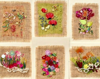 May include: Six small embroidered squares with different floral designs. Each square features a variety of colorful flowers, leaves, and beads on a burlap background.
