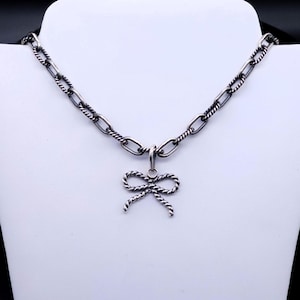 This pendent does not come with a chain but in this photo, it is showcased with a chain that is available in my shop.