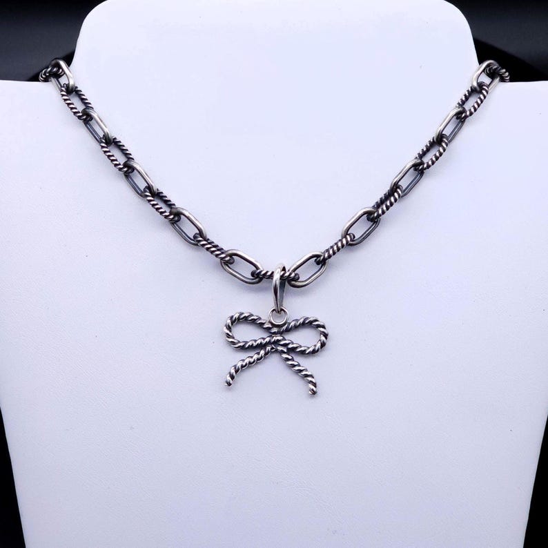 This pendent does not come with a chain but in this photo, it is showcased with a chain that is available in my shop.