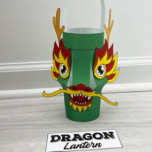 May include: A green paper dragon lantern with red and yellow accents. The lantern has a handle and says "Dragon Lantern" on the bottom.