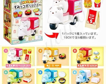 May include: A collection of Sumikko Gurashi miniature delivery vehicles in various colors, each with a different food item. The vehicles are white, yellow, blue, and pink, with the text "Sumikko delivery" on the delivery box. The packaging includes the text "Re-Ment".