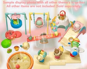 May include: A colorful Sumikkogurashi Park playset with various characters and play areas, including a swing set, a slide, a seesaw, and a sandbox. The set is made of plastic and is designed for children to play with.