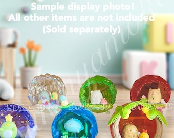 May include: A set of six colorful, dome-shaped toys with different animal characters inside. Each dome has a unique design and features a different animal, including a bear, a penguin, a fish, and a hedgehog. The domes are made of clear plastic and have a variety of colors, including blue, green, red, and purple.